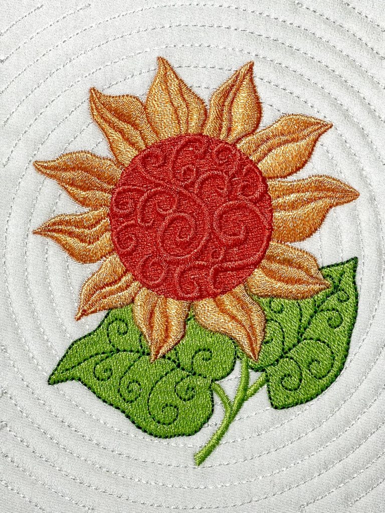 Blume mit Quilt-Hintergrund